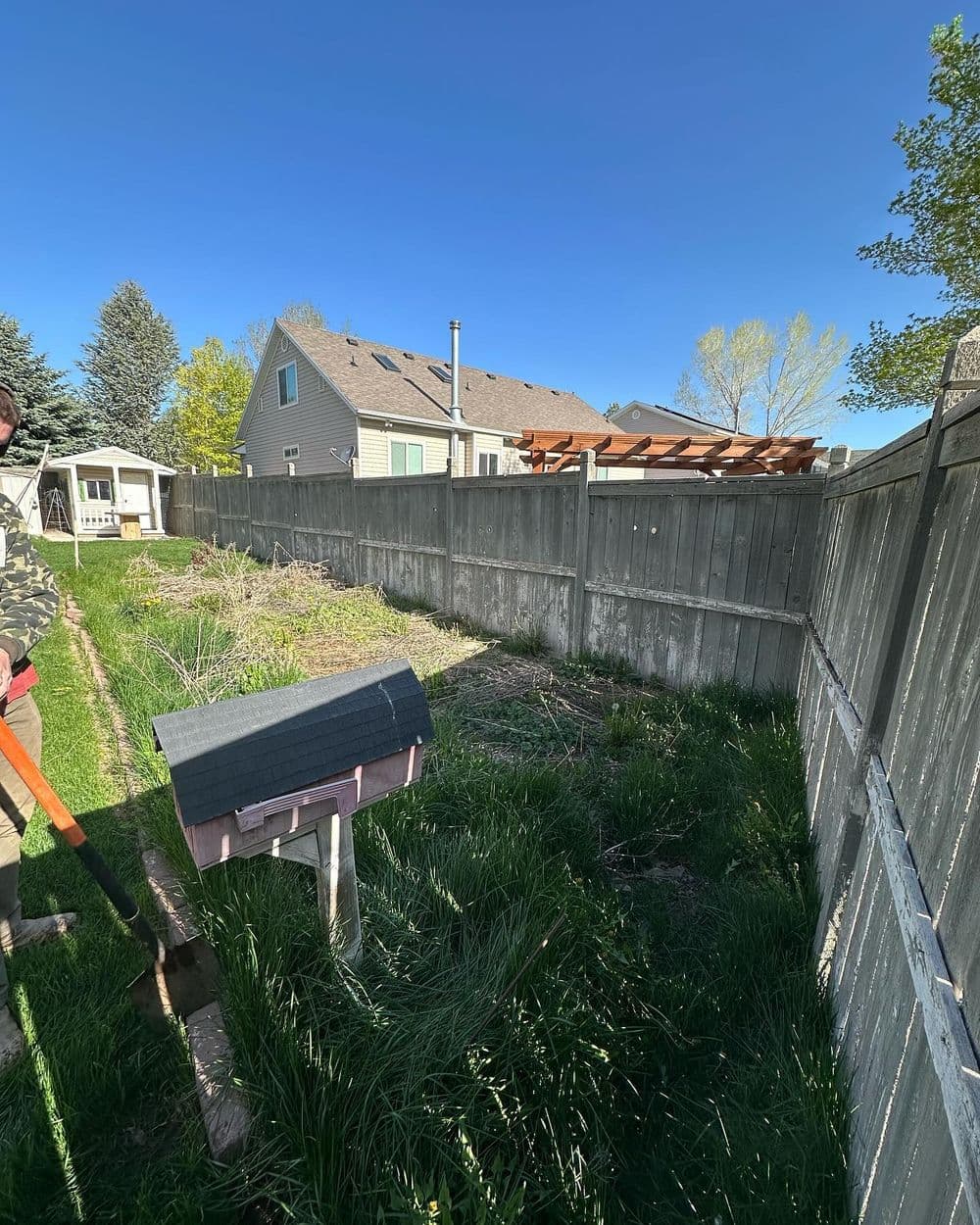 Overgrown Garden Bed Replaced with Sod and Pavers in Tooele
