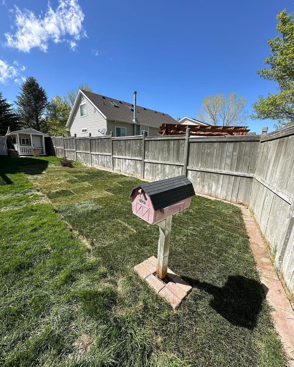 Overgrown Garden Bed Replaced with Sod and Pavers in Tooele